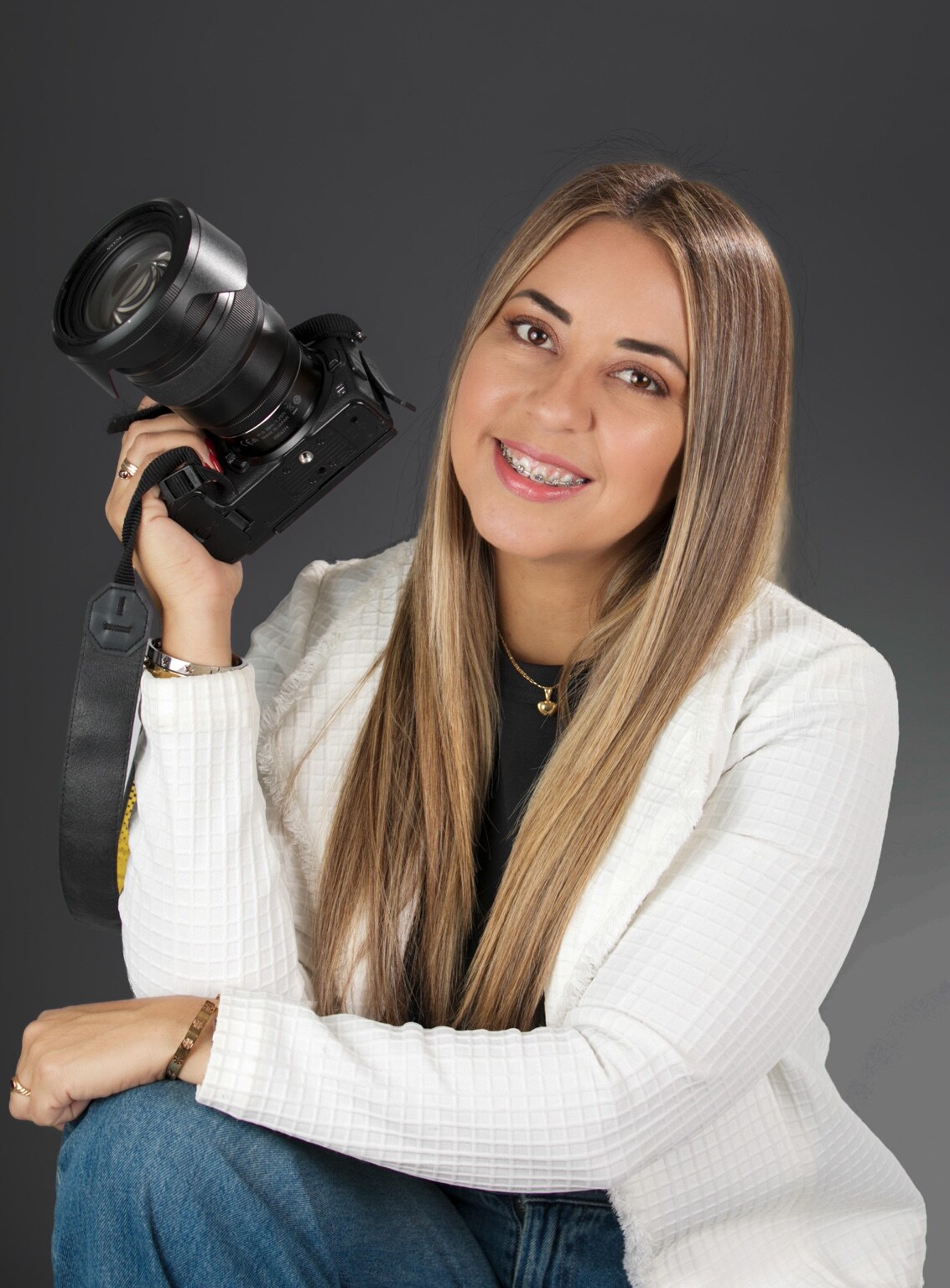 Aneiram Annie Garcia smiling with her camera in the studio