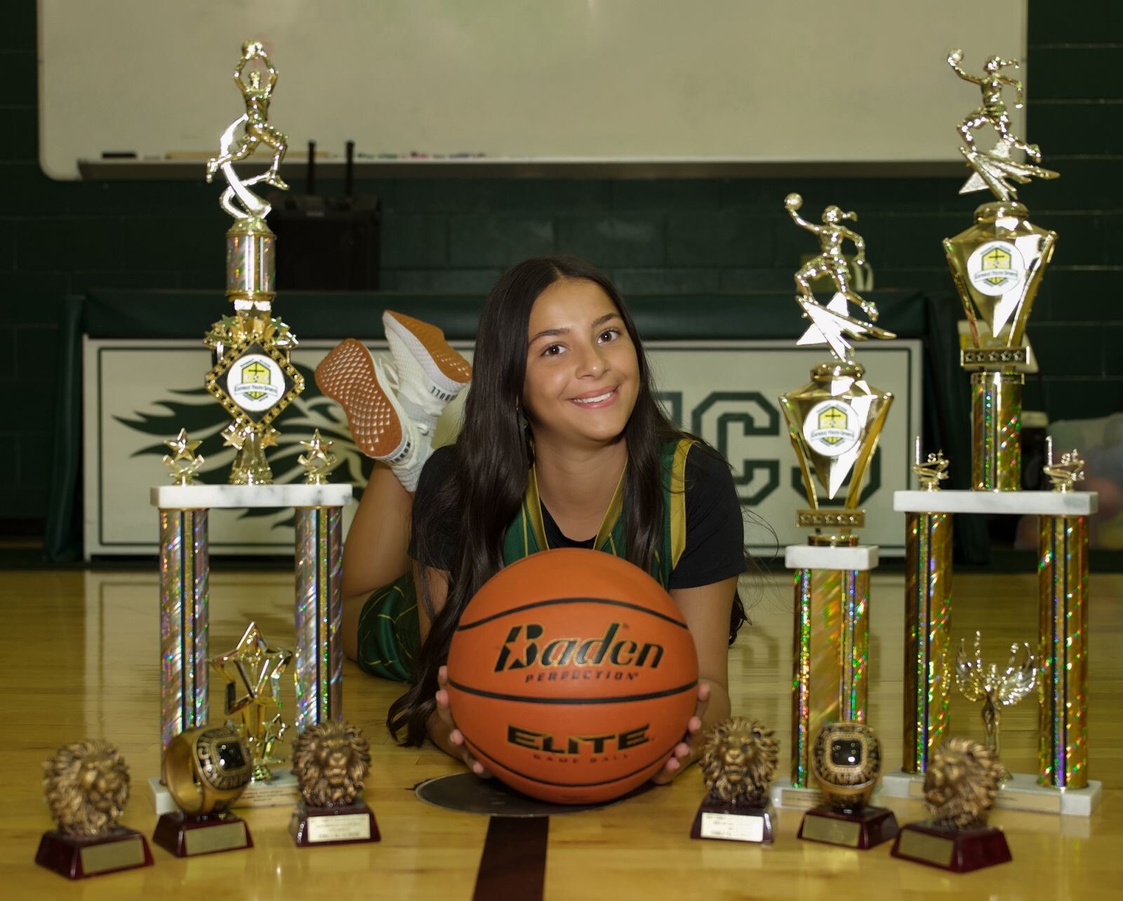 Basketball athlete surrounded by trophies