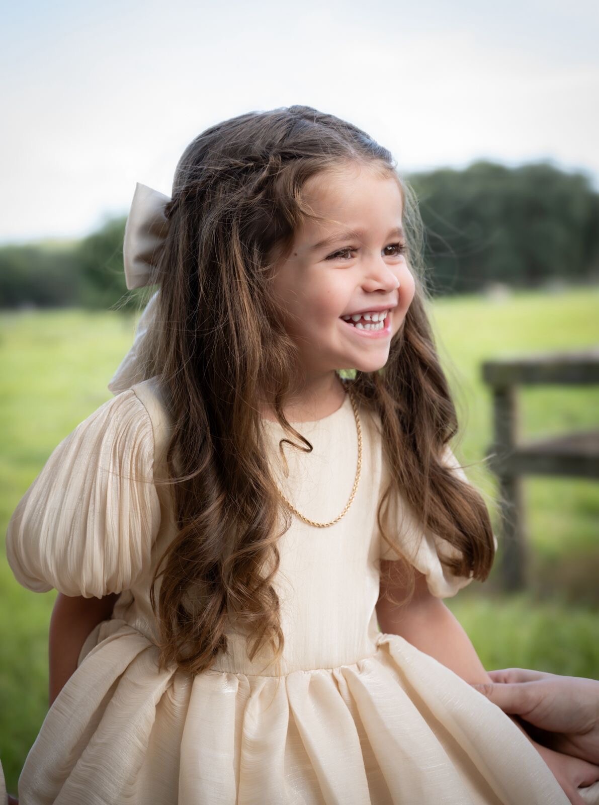 Young girl smiling in a sunlit field