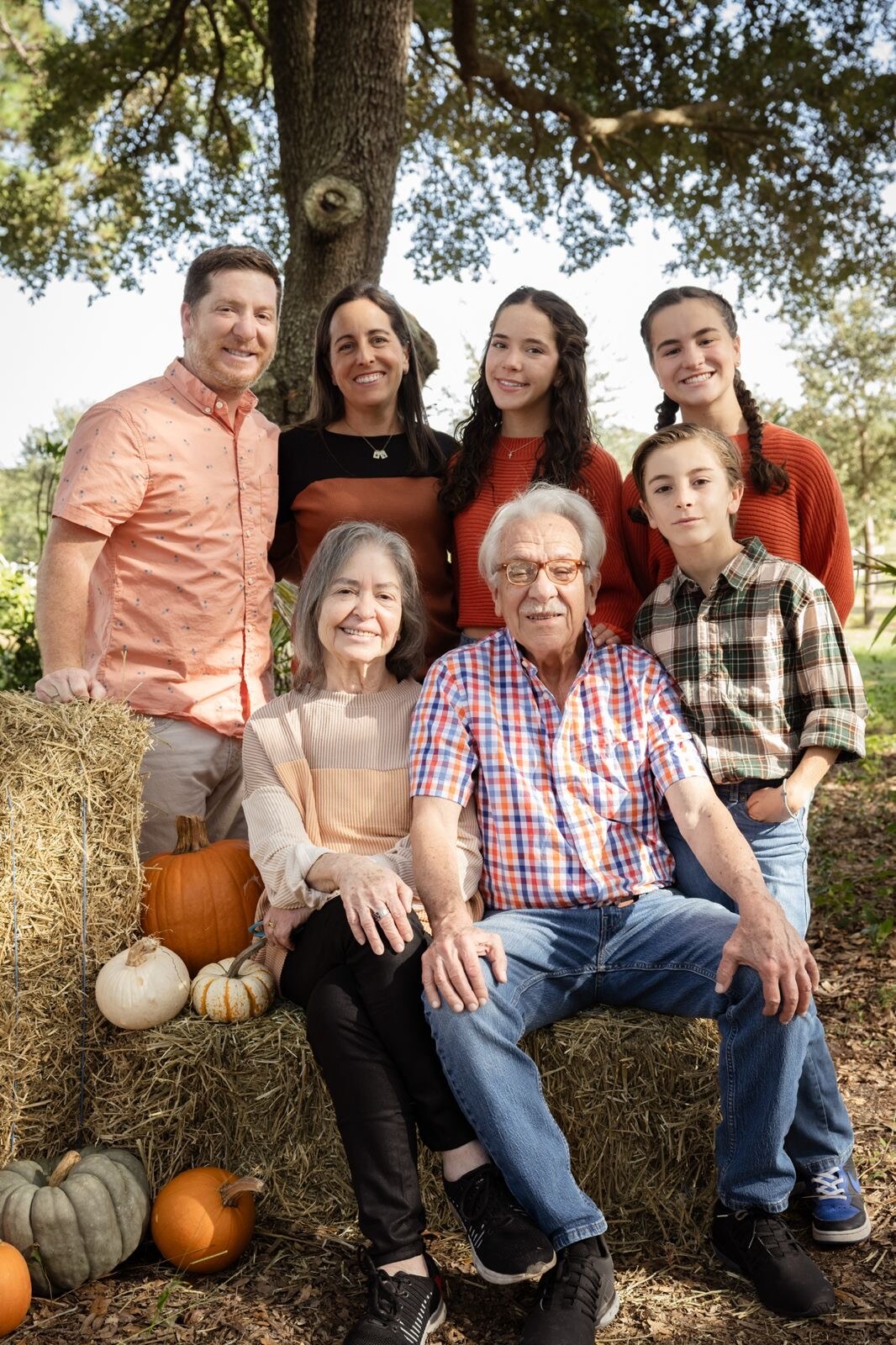 Extended family gathered for an autumn portrait outdoors