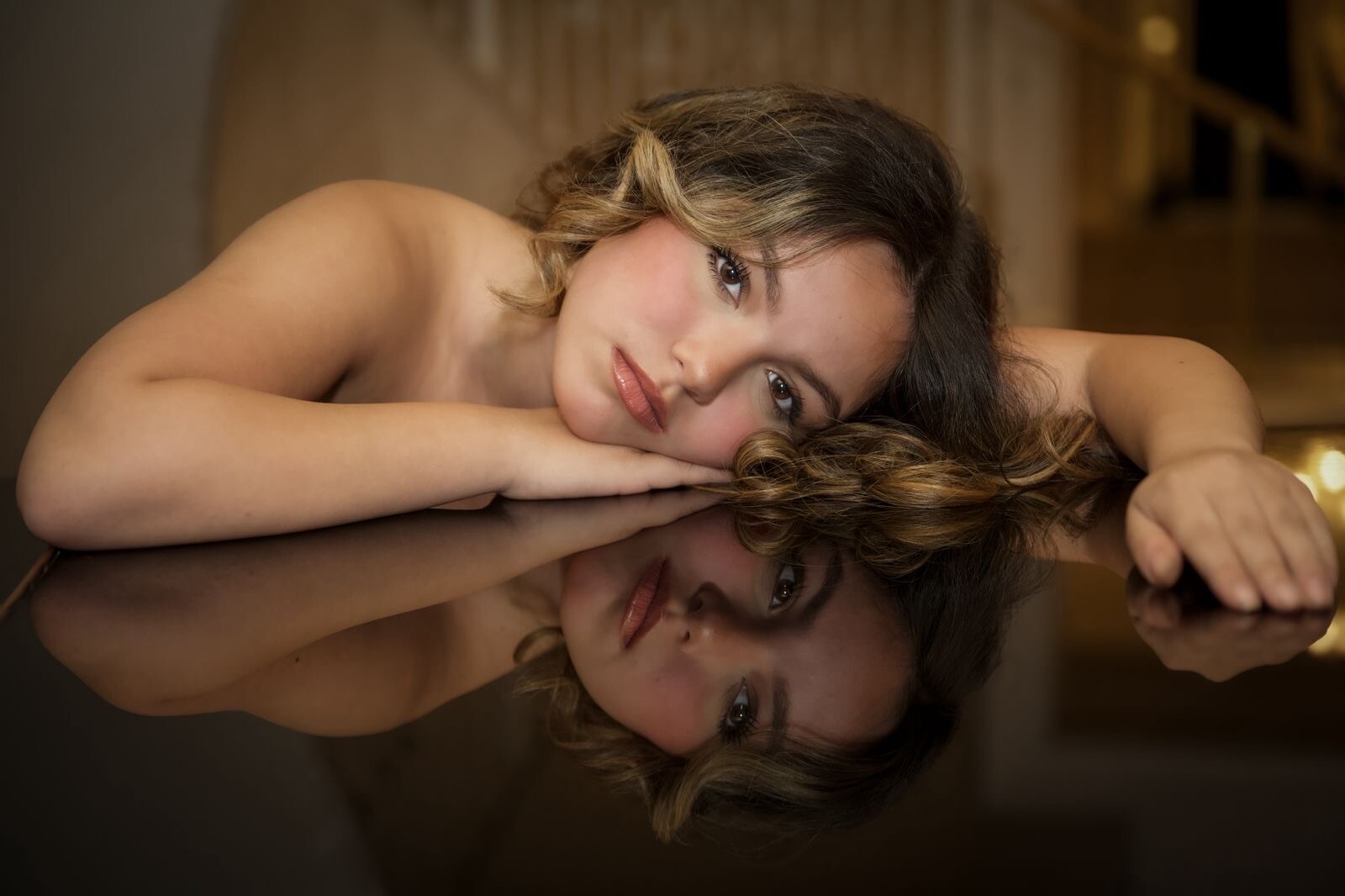 Editorial portrait reflected in a grand piano