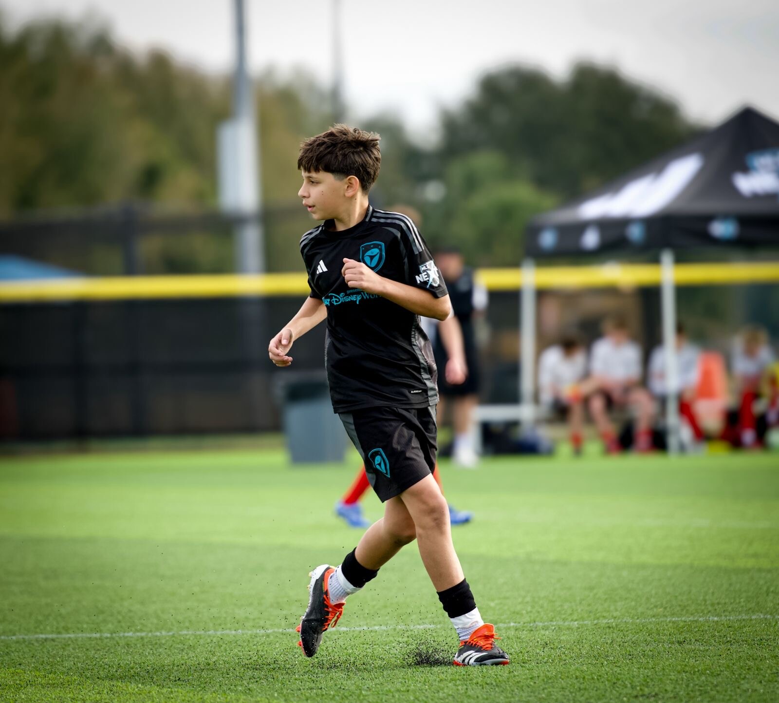 Youth soccer player running during a match