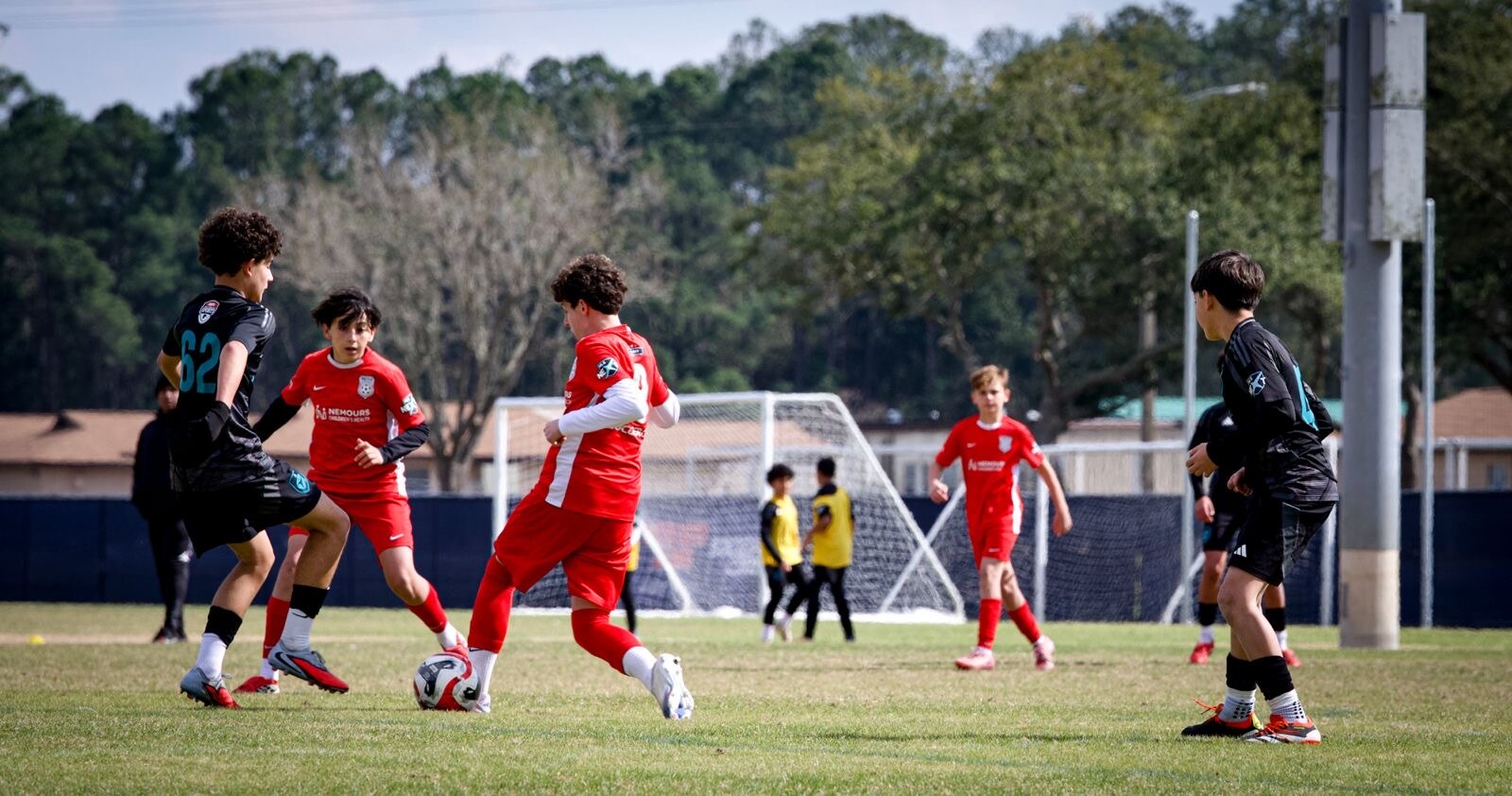 Youth soccer players in motion during a match
