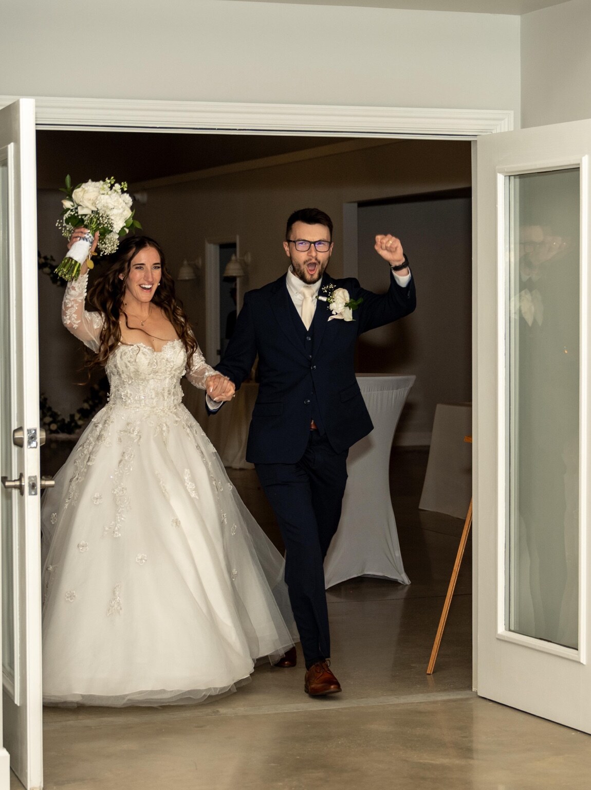 Newlyweds celebrating as they enter their reception